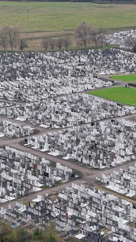 Vertical Drone orbit and descent over Waltham Abbey Jewish cemetery graves.