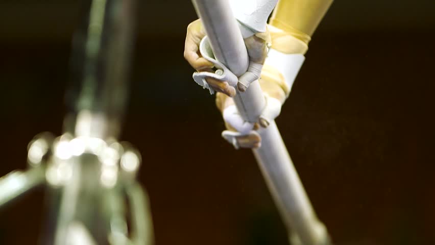 gymnast hands on uneven bars with chalk