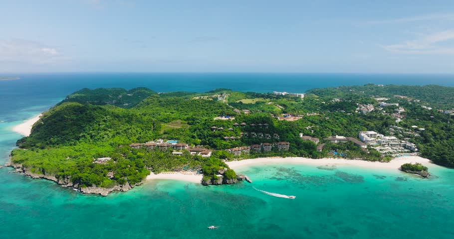 Beach resorts with white sands and tourist boat running over transparent sea water. Boracay Island. Philippines.