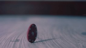 Poker chip spinning on table medium zoom slow motion 4k shot selective focus - Powered by Shutterstock - Get 15% off with code: PIKWIZARD15