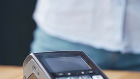NFC credit card payment being made, showing contactless technology, digital transactions, and modern cashless payment methods in a retail setting. - Powered by Shutterstock - Get 15% off with code: PIKWIZARD15