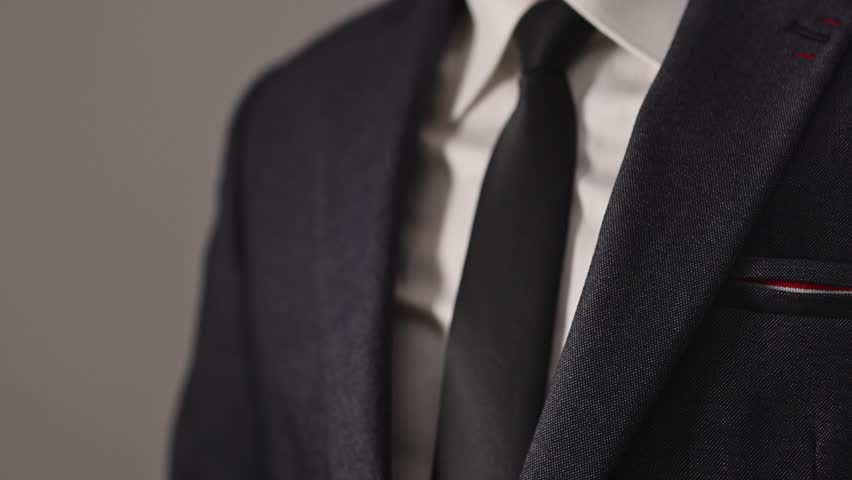 Businessman secretly pulling cash from suit pocket, bribery concept, 4K with selective focus