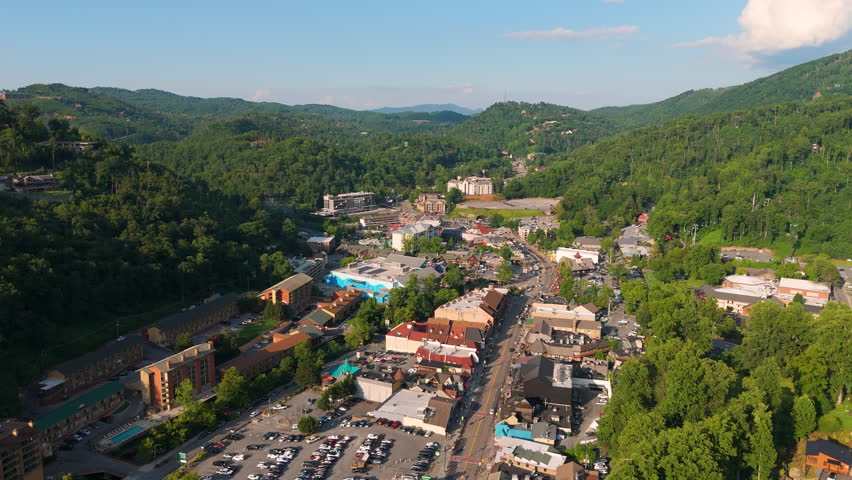 Aerial view of Gatlinburg, Tennessee with downtown hotels, restaurants and tourist shops along the Parkway street surrounded by Appalachian Mountains.
