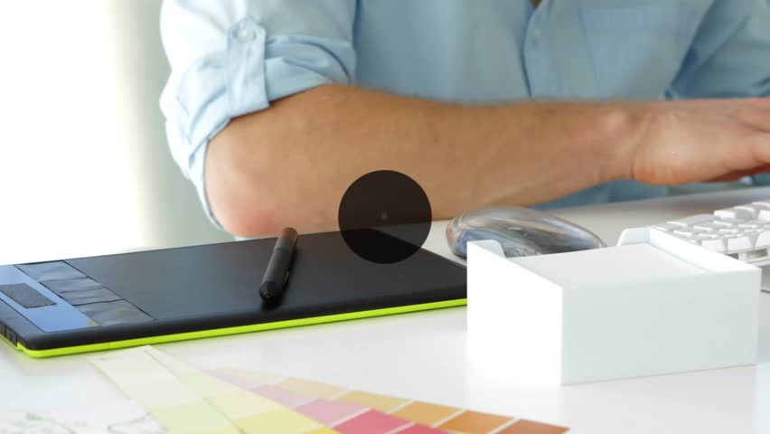 Animation of connected icons over midsection of caucasian man drawing on graphics tablet. Digital composite, multiple exposure, communication, business, art, abstract and technology concept.