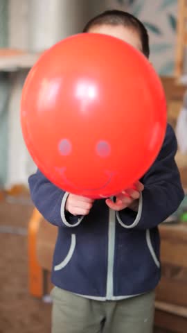 Slow-Motion Portrait of a Boy with a Red Balloon