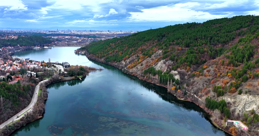 Mountain lake in autumn, backward moving drone, view above