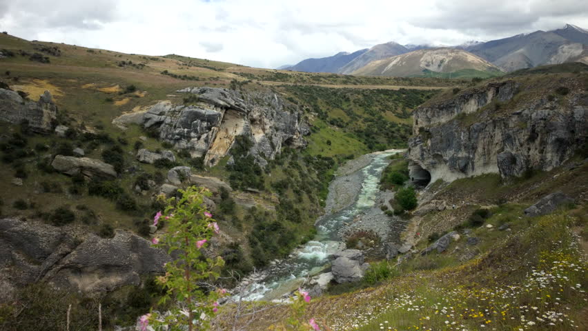 River Gorge Through Rocky Canyon With Wildflowers