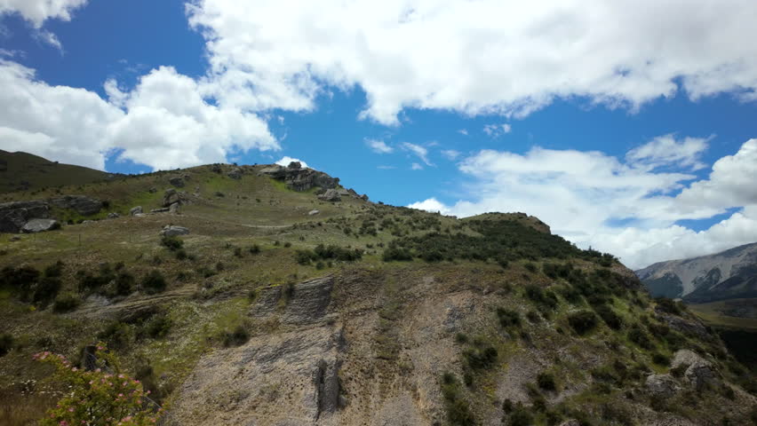 Rugged Hillside Trail Under Blue Sky And Clouds