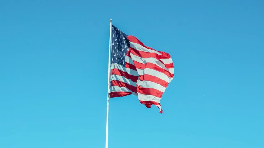 United States flag waving in the wind. 