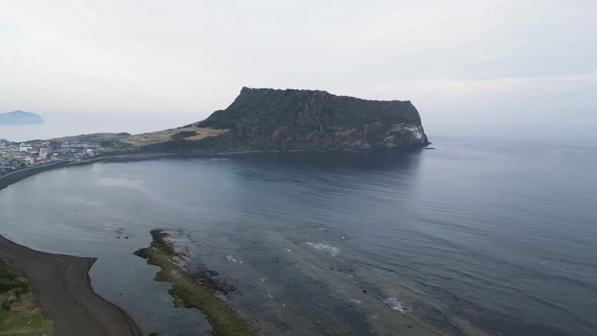 Jeju-do, Seongsan Ilchulbong landscape, volcanic tuff cone, Sunrise peak, Jeju Island, South Korea, Seongsan-ri, Seogwipo, Jeju Province landscape view in a sunny day, with sea, aerial drone view