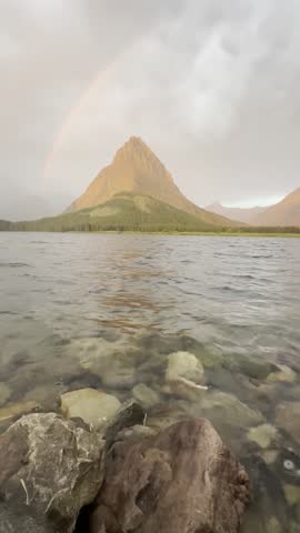 A rainbow appears during a storm at Many Glacier - Swiftcurrent Lake - Montana 