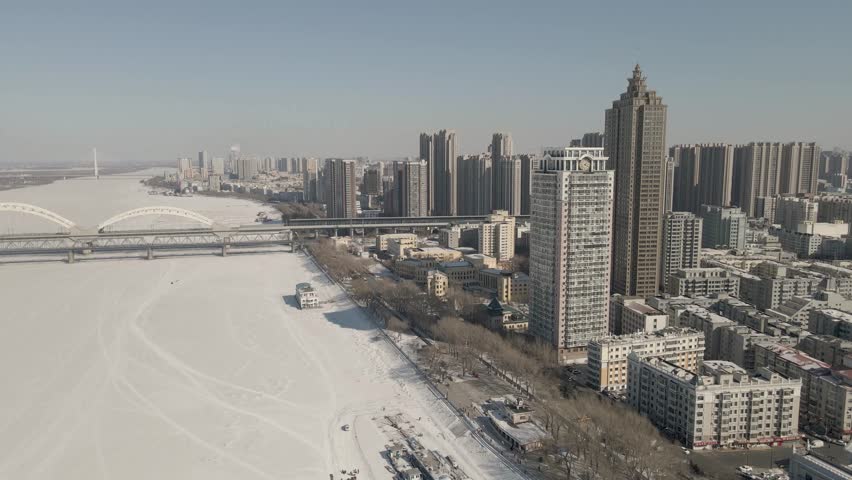 This 4K aerial time-lapse video presents Harbin’s distinctive charm, blending modern CBD architecture, historic Saint Sophia Cathedral, Grand Theatre, magical Ice-Snow World with grand bridges and smooth urban traffic flow. It captures the perfect fusion of cultural landmarks, winter ice-snow scenery and dynamic urban traffic in northern China’s iconic ice city, perfect for tourism promotion and winter urban content.