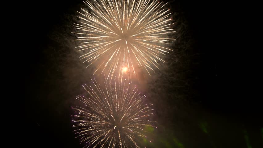 Dramatic green spotlights fan out over the Perfume River at night, illuminating boats and reflecting on the dark water surface.