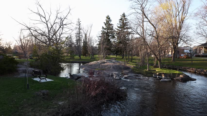 City park with small river in spring. Stewart Park In Perth, Ontario, Canada.