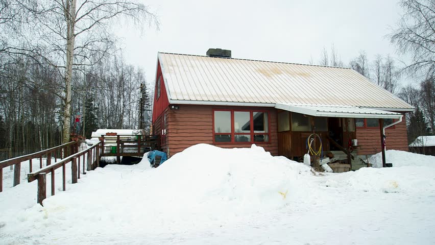 Wide shot of wood cabin in the snow