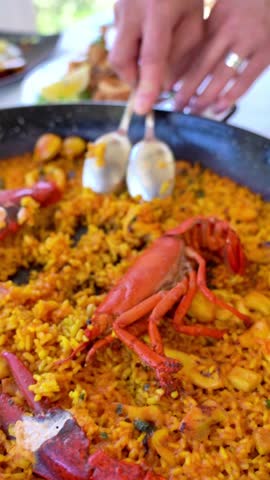 A plate of food with a crab on it. The crab is on top of the rice and is surrounded by other food items