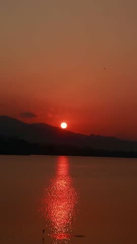 Sunset Over Water and Mountains