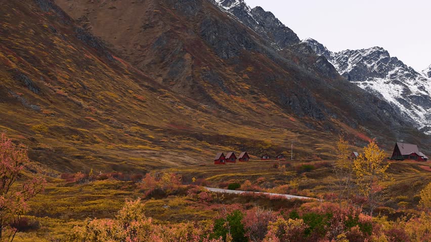 Scenic late autumn hatcher pass landscape with snow-capped mountains in Alaska.