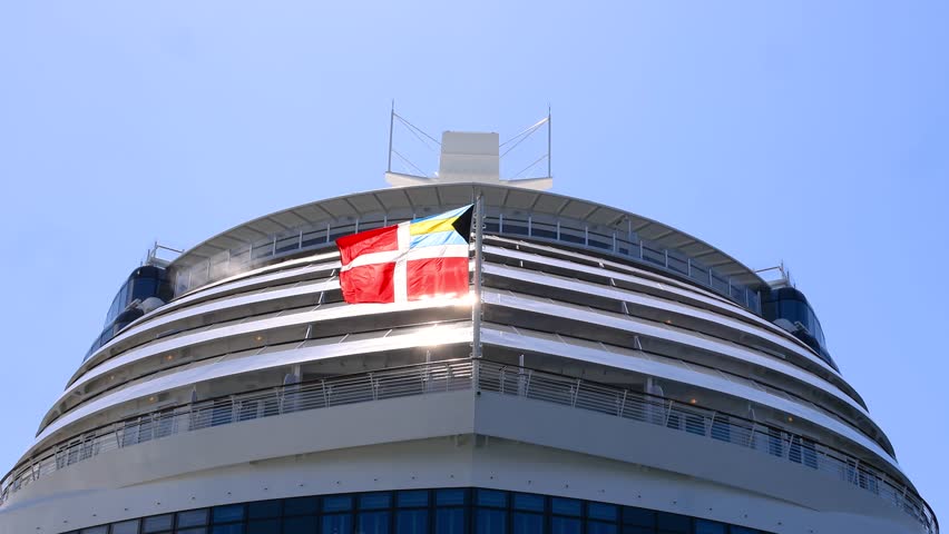 The Bahamas Courtesy Flag flag also known as the Bahamian Civil Ensign waving on cruise ship bow.