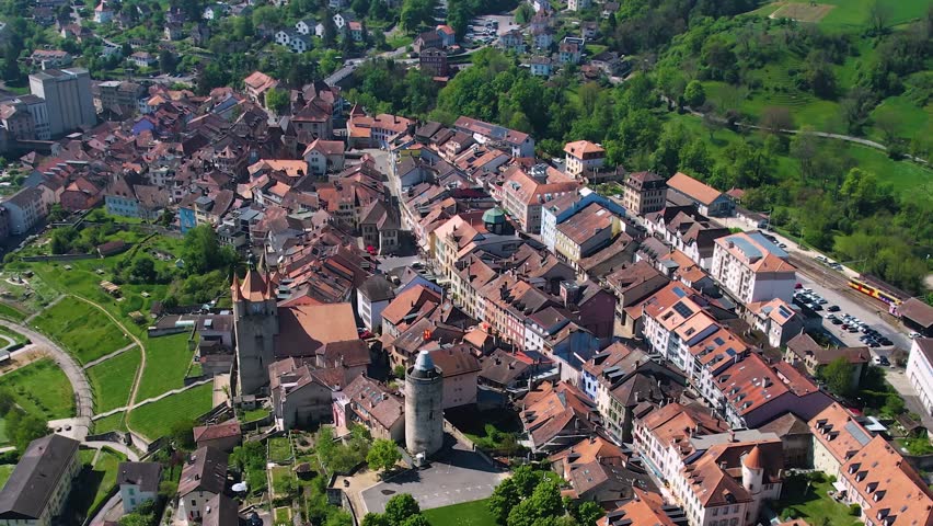 A panoramic aerial view around the old town of the city Orbe in Switzerland on a sunny spring noon

