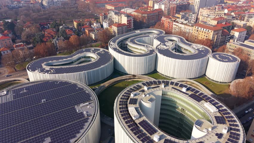 Aerial drone shot of the modern bocconi university campus in milan, italy. The unique architecture features buildings with roofs covered in solar panels