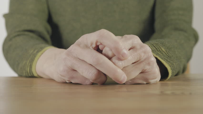 A green elastic rubber band stretched to show the tension and elasticity of the material
