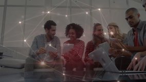 business team collaborating on devices in office lounge, showing glowing network connection overlay. Collaboration, teamwork, digital, networking, innovation, modern, professional - Powered by Shutterstock - Get 15% off with code: PIKWIZARD15