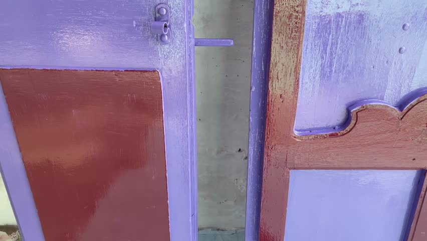 Old Wooden Doors with Worn Paint and Metal Handles Side by Side