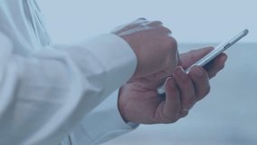 Animation of clock moving over hands of caucasian businessman using smartphone. business, time, network and technology concept digitally generated video. - Powered by Shutterstock - Get 15% off with code: PIKWIZARD15