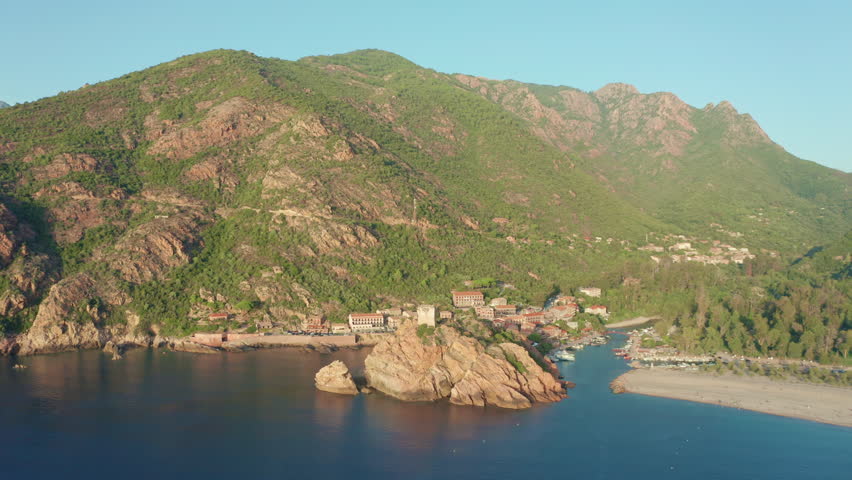 Plage de Porto Genoese Tower Piana Corsica aerial drone view of dramatic rocky cliffs and lush Mediterranean landscape