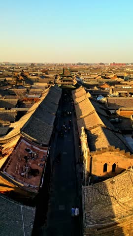 Aerial view of the architecture along Xi Da Jie, with the road contrasting with the rooftops, Jin Zhong Shi, Shan Xi Sheng, China.