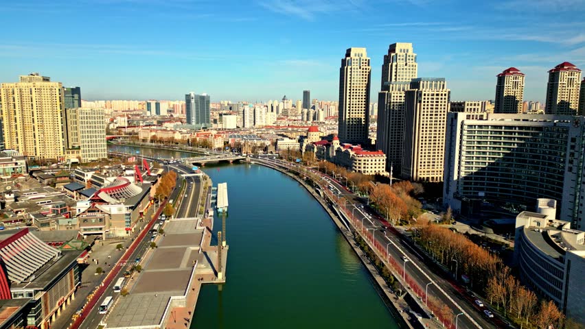 Aerial view of the Haihe River winding through the city, framed by modern buildings and roads, showcasing urban development, Tianjin, Tianjin, China.