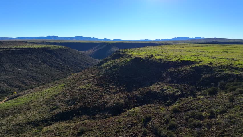 Aerial view of the rugged landscape of Agua Fria National Monument, showcasing a deep canyon and contrasting green vegetation, Black Canyon City, Arizona, United States.