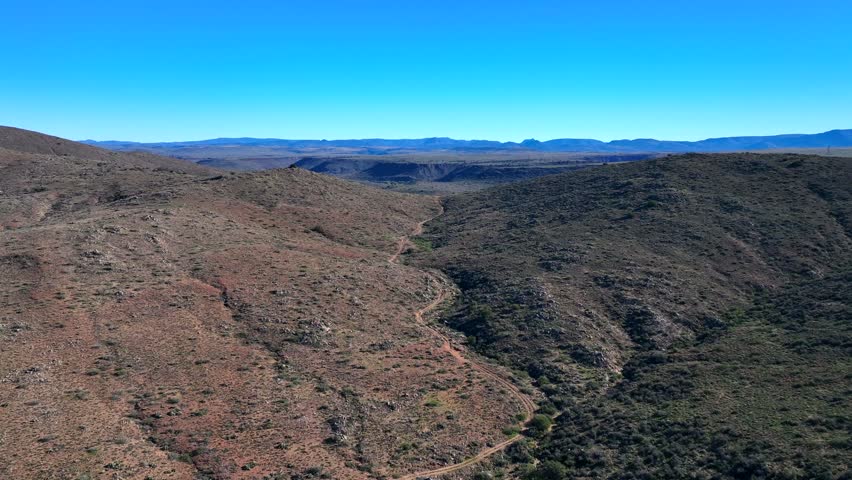 Aerial view of the Agua Fria National Monument showcasing the arid landscape and contrasting green vegetation, Black Canyon City, Arizona, United States.