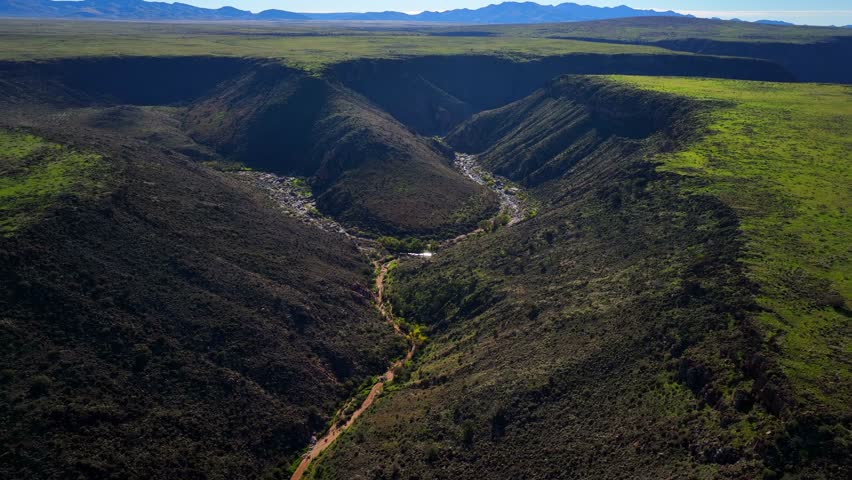 Aerial view of the canyon with its contrasting dark shadows and sunlit green vegetation, Agua Fria National Monument, Black Canyon City, United States.