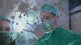 Animation of covid 19 cells over diverse surgeons wearing face masks in operating theatre. global covid 19 pandemic, medicine and healthcare services concept digitally generated video. - Powered by Shutterstock - Get 15% off with code: PIKWIZARD15