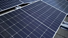 High angle close up view of blue solar panels installed on a rooftop. Photovoltaic technology for clean renewable energy generation. Alternative power and sustainability concept. - Powered by Shutterstock - Get 15% off with code: PIKWIZARD15