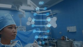 male surgeon adjusting female surgeon cap inside operating room, showing floating digital DNA helix. Medical, healthcare, clinical, innovation, precision, teamwork, professionalism - Powered by Shutterstock - Get 15% off with code: PIKWIZARD15