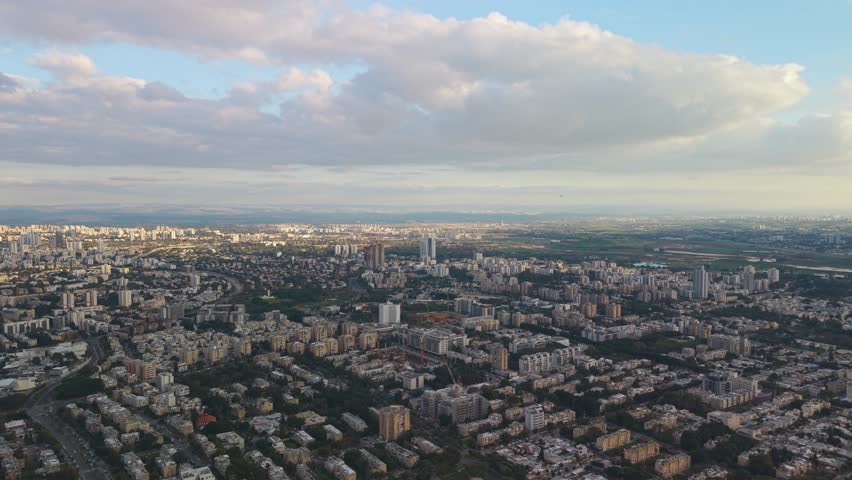 Dramatic sky over East Tel Aviv during a golden hour sunset, showing the peaceful residential side of the metropolis under a moody atmosphere.