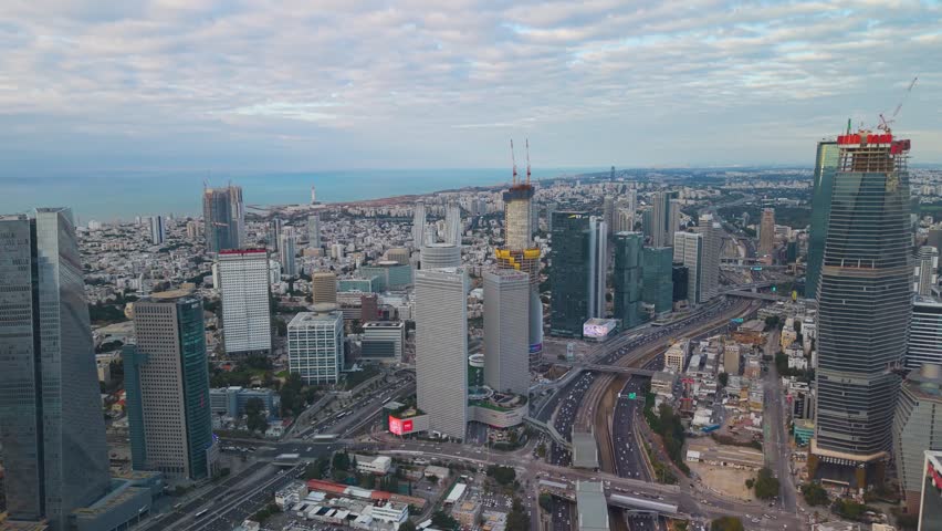 Tel Aviv's iconic business district featuring the Azrieli complex and surrounding modern skyscrapers under a bright Mediterranean sun