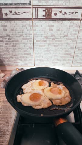 Frying Eggs with Green Bell Pepper in Pan on Gas Stove, Homemade Breakfast Cooking, Fresh Eggs Sunny Side Up
