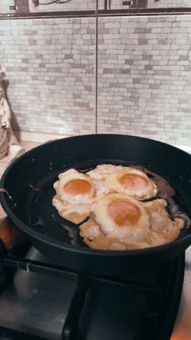 Frying Eggs with Green Bell Pepper in Pan on Gas Stove, Homemade Breakfast Cooking, Fresh Eggs Sunny Side Up
