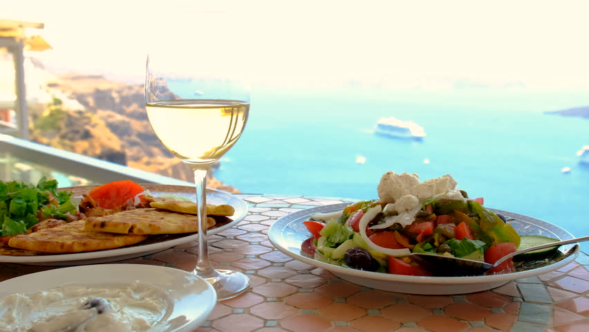 Greek salad and wine in Greece in a restaurant. Selective focus.