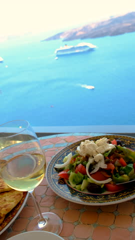 Greek salad and wine in Greece in a restaurant. Selective focus.
