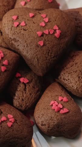 Vertical video. Heart shaped chocolate cookies made for St. Valentines day.
