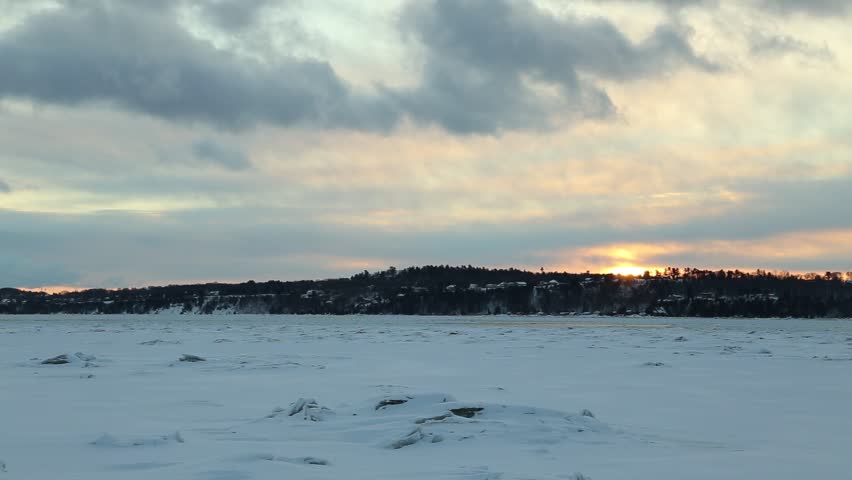 Winter panorama with clouds moving over the frozen St. Lawrence River and the south shore, Cap-Rouge area, Quebec City, Quebec, Canada