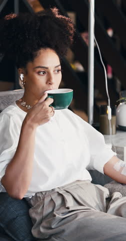 IV drip, happy and woman with coffee at wellness center for vitamins, nutrition and infusion. Healthcare, medical lounge and person listen to music with fluid for hydration, minerals and supplements