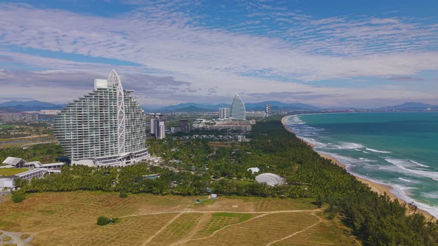  Aerial footage of Haitang Bay in Sanya, Hainan, with Luxury Hotels and Resorts Situated along the beach.