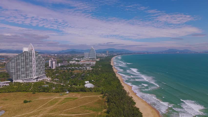  Aerial footage of Haitang Bay in Sanya, Hainan, with Luxury Hotels and Resorts Situated along the beach.