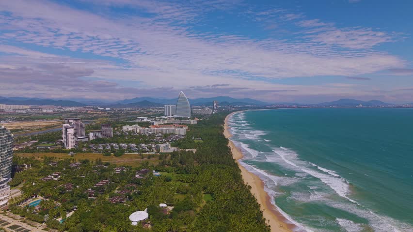  Aerial footage of Haitang Bay in Sanya, Hainan, with Luxury Hotels and Resorts Situated along the beach.